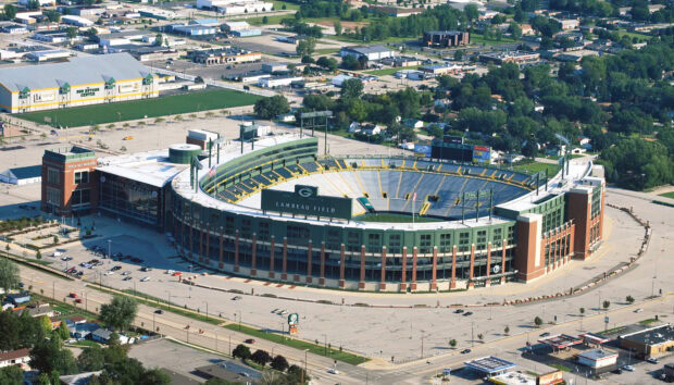 Aerial view of Lambeau Field stadium surrounded by city streets and buildings