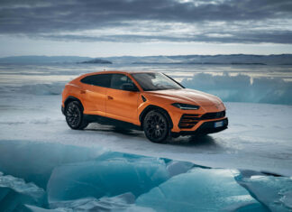 Orange Lamborghini Urus parked on icy terrain with glacial landscape in background