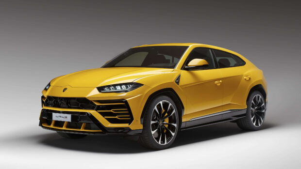 Yellow Lamborghini Urus sports car shown in a studio setting with sharp design lines