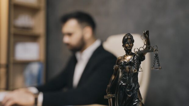 Lady Justice statue representing lawyer in office environment