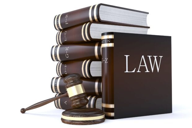 A law book with legal codes and a judge gavel symbolizing lawyer concepts