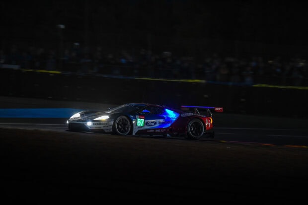 Ford race car with EcoBoost logo speeding at Le Mans at night