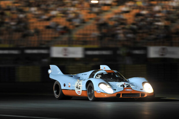 Classic Le Mans race car number 42 speeding on the track at night