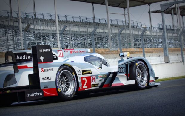 A Le Mans race car with Audi branding parked on the racetrack