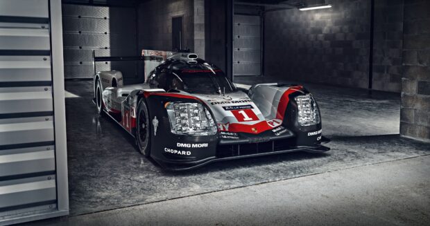Porsche racing car in Le Mans design parked in a garage environment