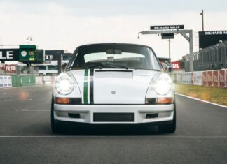 Classic Le Mans car on race track with headlights on