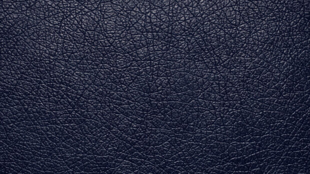 Close up view of leather texture showing natural patterns and grain on a dark surface