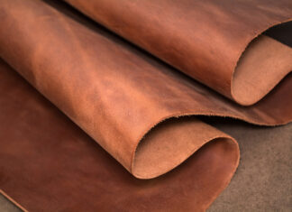 Close up of soft brown leather texture rolled up for crafting