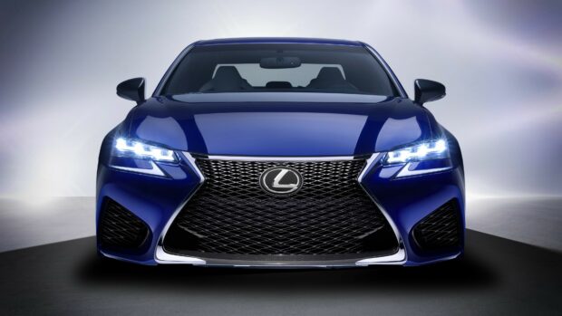 Front view of a blue Lexus with headlights on displayed in high quality
