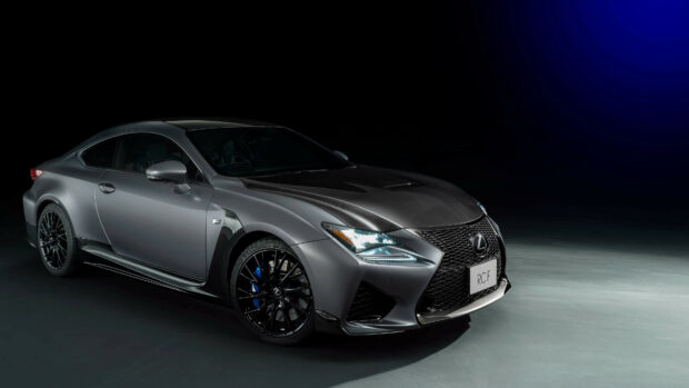 Matte gray Lexus sports car with carbon fiber details in a dark studio setting