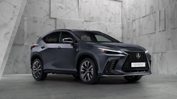 A sleek Lexus NX 450h hybrid car is parked in a modern marble walled showroom