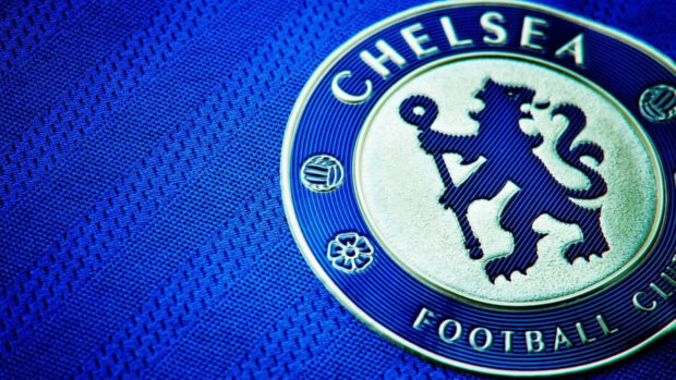 Close up of a Chelsea emblem on a textured blue fabric showing detailed logo design