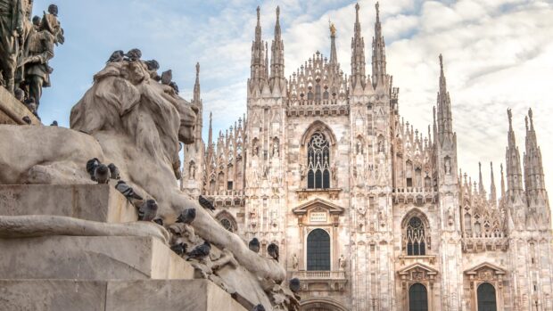 Detailed view of Milan cathedral architecture with statues and birds in Lombardy region