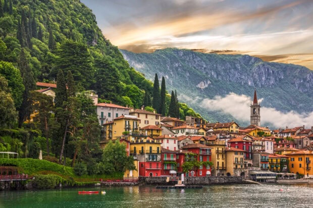Colorful houses and lush green hills in Lombardy town by the lake