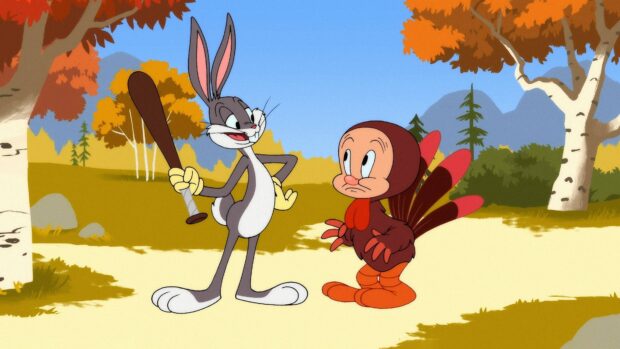 Bugs Bunny holding a baseball bat next to a character dressed as a turkey in a forest scene