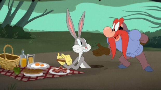 Bugs Bunny wearing yellow gloves during a picnic with Yosemite Sam in the forest area