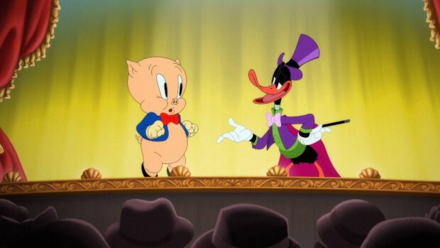 Daffy Duck and Porky Pig characters from Looney Tunes on the stage of a theater