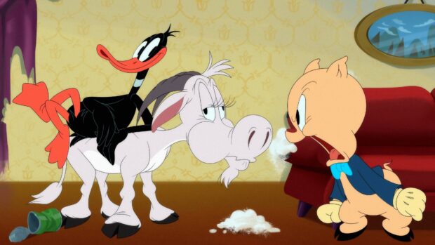 Daffy Duck sitting on a goat with Porky Pig angrily facing them in a Looney Tunes scene