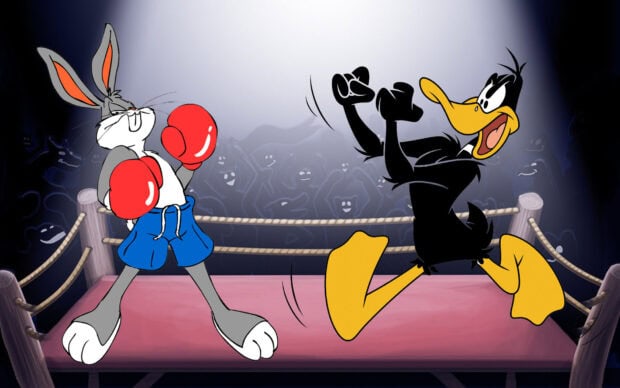 Bugs Bunny wearing boxing gloves facing Daffy Duck in a boxing ring with a cheering crowd