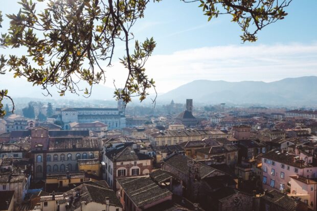 Historic architecture of Lucca Italy viewed from above with mountains in the background