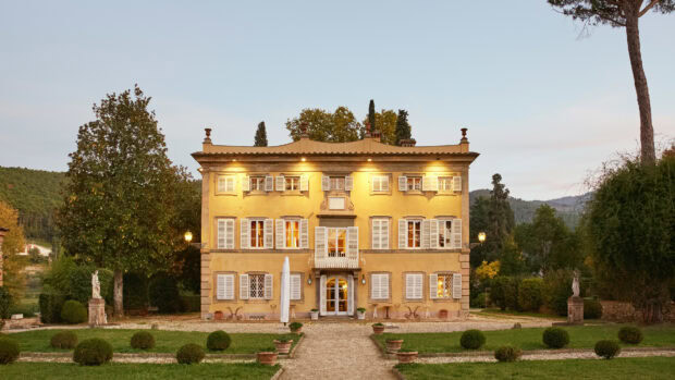 A historic villa surrounded by greenery in Lucca Italy at dusk