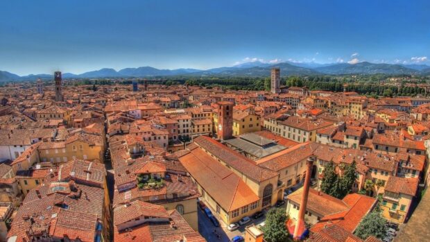 Scenic view of Lucca Italy cityscape with terracotta rooftops and distant mountains