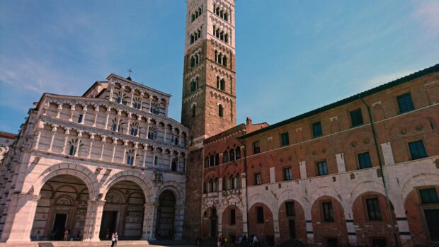 Historic architecture in Lucca Italy with ancient tower and ornate arches