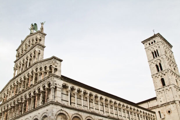Historic architecture in Lucca Italy with detailed stone carvings and arches