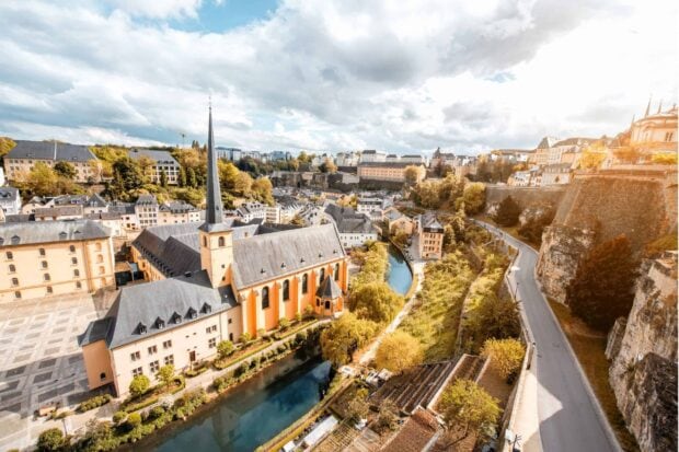 Historic Luxembourg city with river and church in scenic autumn setting