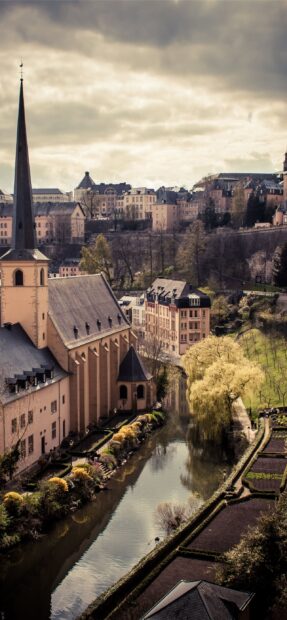 Historic Luxembourg cityscape with church and river in spring season