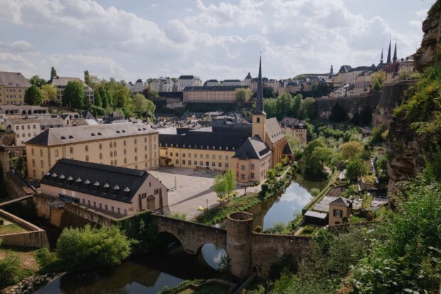 Historic architecture and river view in Luxembourg cityscape with lush greenery and peaceful surroundings