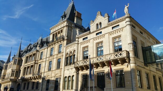 Historic architecture of Luxembourg with flags and clear blue sky