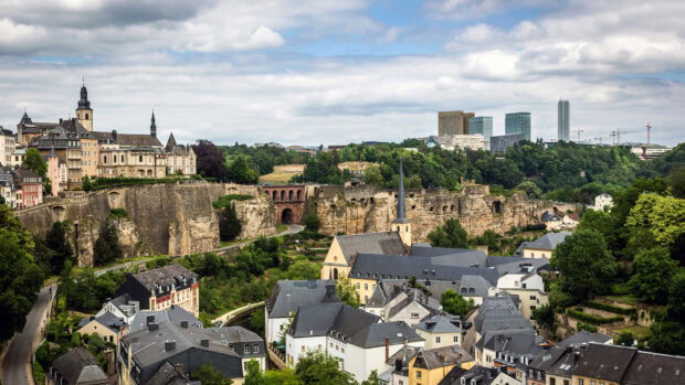 Scenic view of Luxembourg city with historic architecture and lush greenery in summer