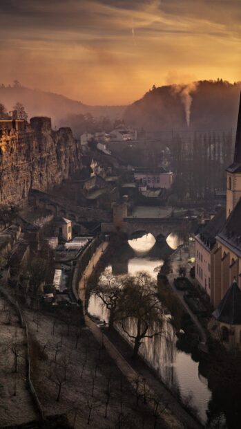 Historic Luxembourg cityscape with river and old fortress during sunset in Luxembourg