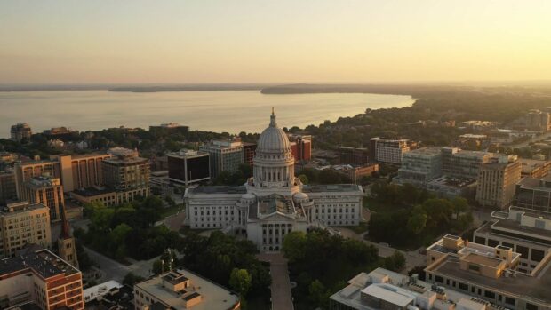 The Wisconsin State Capitol building in Madison Wisconsin during sunset with lake view in the background