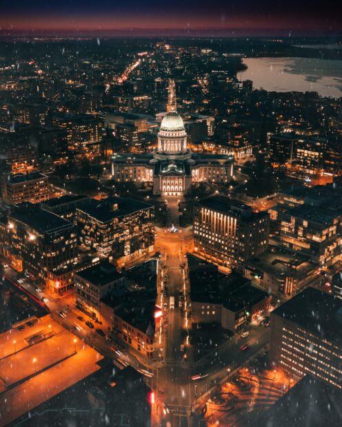 Night view of Madison Wisconsin with the Capitol building illuminated and city lights glowing