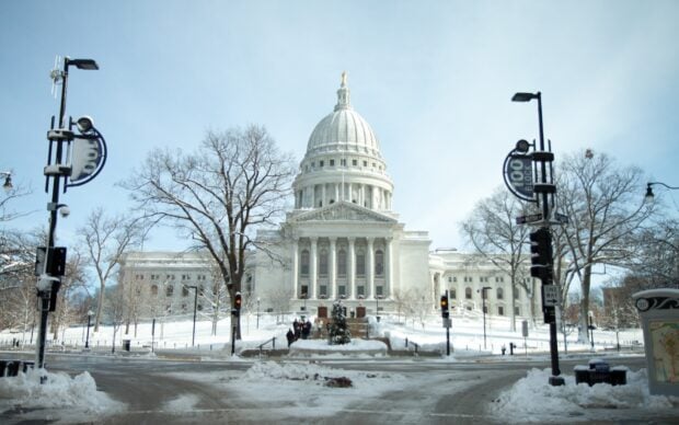 The Madison Wisconsin state capitol building covered with snow in winter