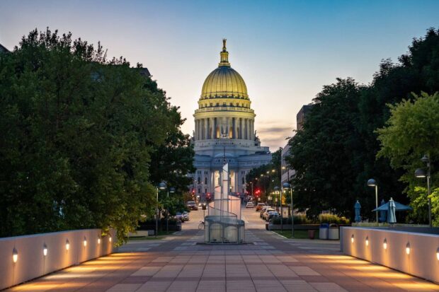 The view of Madison Wisconsin Capitol at dusk with trees and street lights lining the walkway