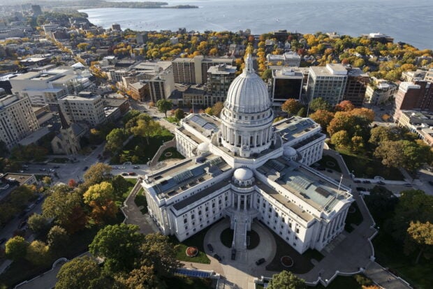 The Wisconsin state capitol building surrounded by autumn foliage in Madison Wisconsin