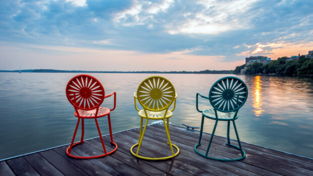 Colorful chairs on a lakeside dock in Madison Wisconsin at sunset