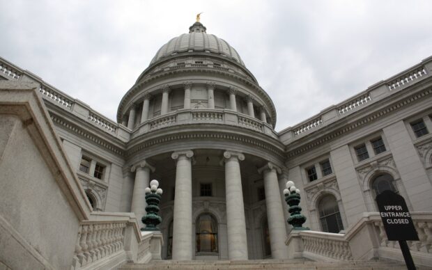 The Capitol building in Madison Wisconsin with grand columns and dome under cloudy sky