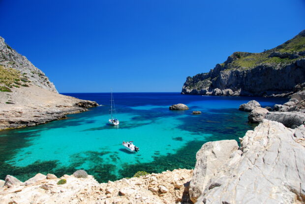 Clear turquoise waters and rocky coastline in Mallorca bay