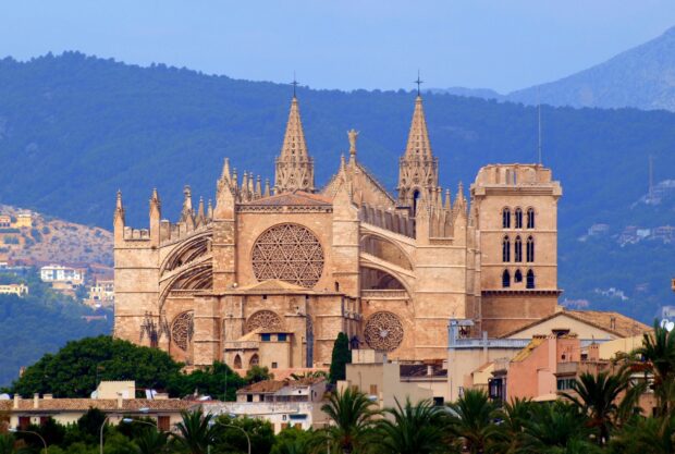Stunning Mallorca architecture with historic cathedral and lush greenery in the background