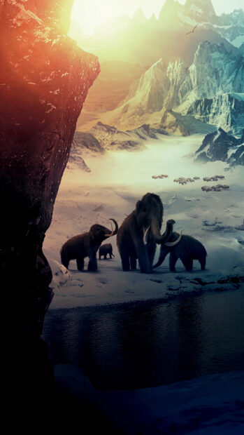 A herd of mammoth walking in a snowy mountain valley with a river nearby