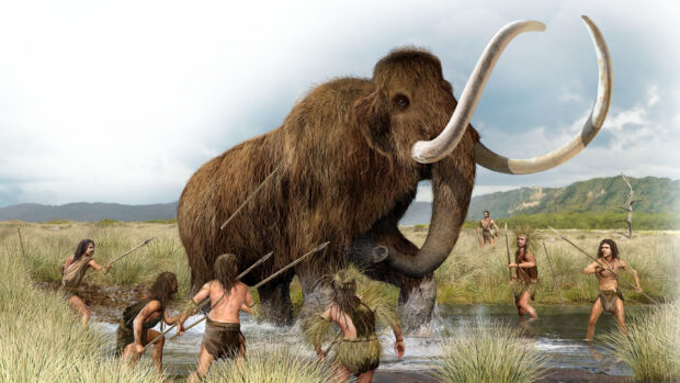 Prehistoric mammoth surrounded by hunters in a grassy wetland scene