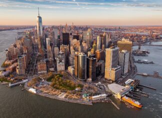 A stunning aerial view of Manhattan with its iconic skyscrapers and waterfront in golden sunlight