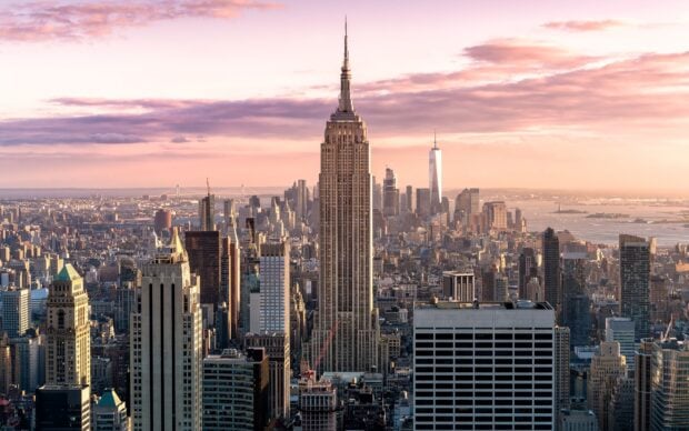 Manhattan skyline featuring iconic buildings during sunset with clear sky and cityscape view