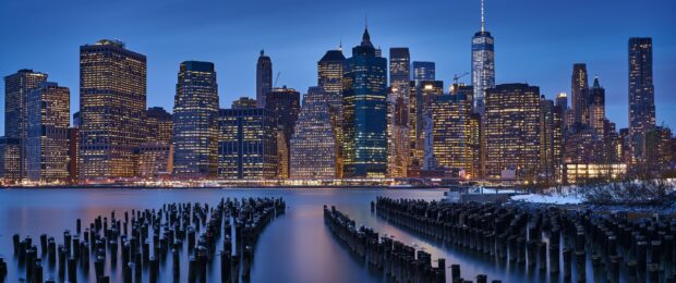 Manhattan skyline with historical wooden pilings at dusk in Manhattan