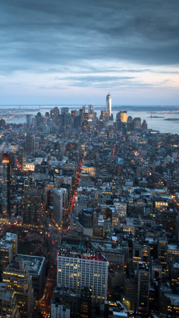 The Manhattan cityscape at dusk showcasing illuminated streets and skyscrapers