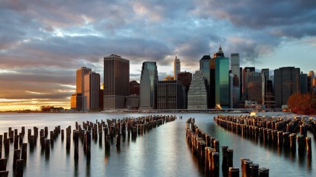 Manhattan skyline with Manhattan during sunset reflected on the water